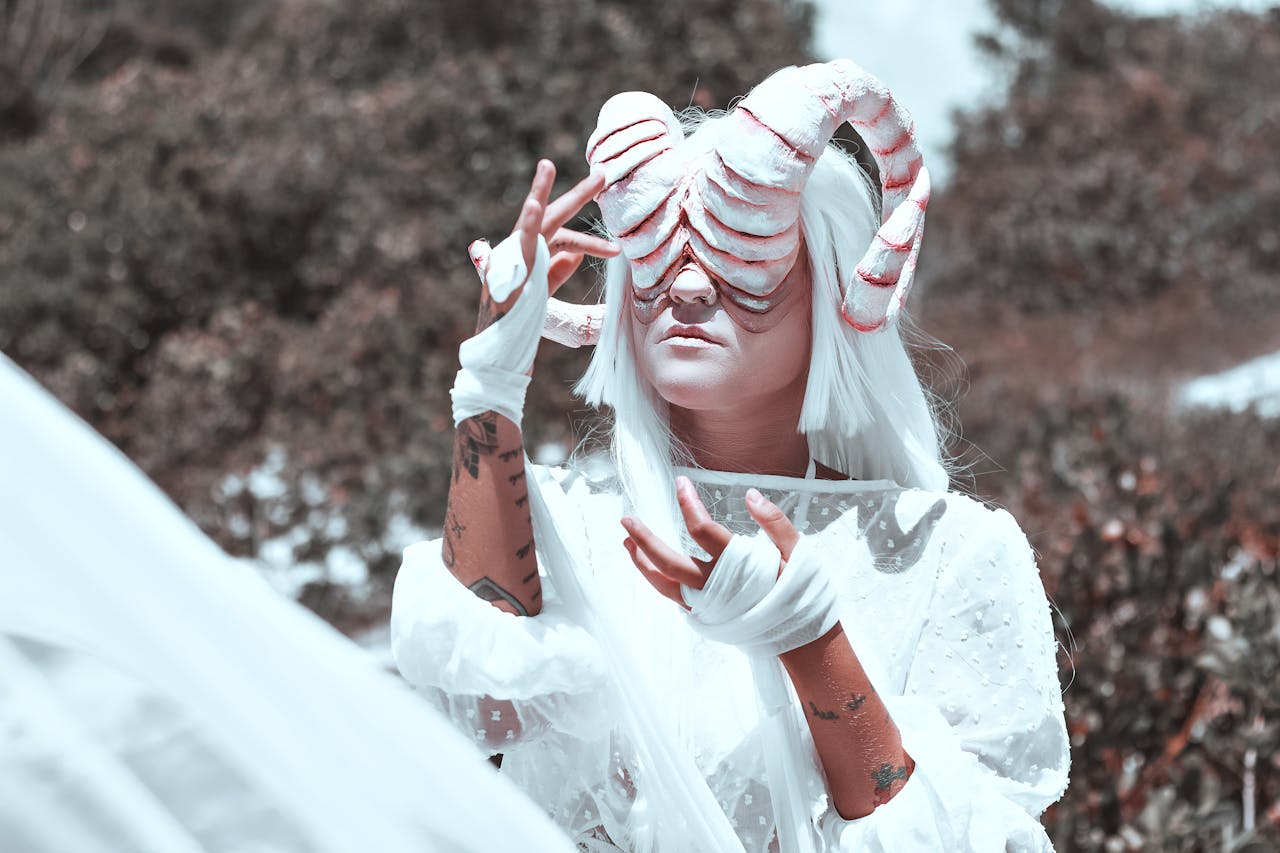 Surreal fantasy portrait featuring a person in a horned costume with a white outfit in an outdoor setting.