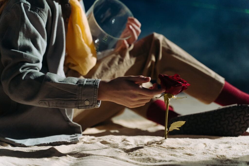 Inspired by literature, a person touches a rose, symbolizing creativity and wonder.